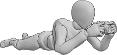 Pose Reference- Lying holding camera pose - Male is lying, leaning on his elbows, holding a camera with both hands and taking a picture